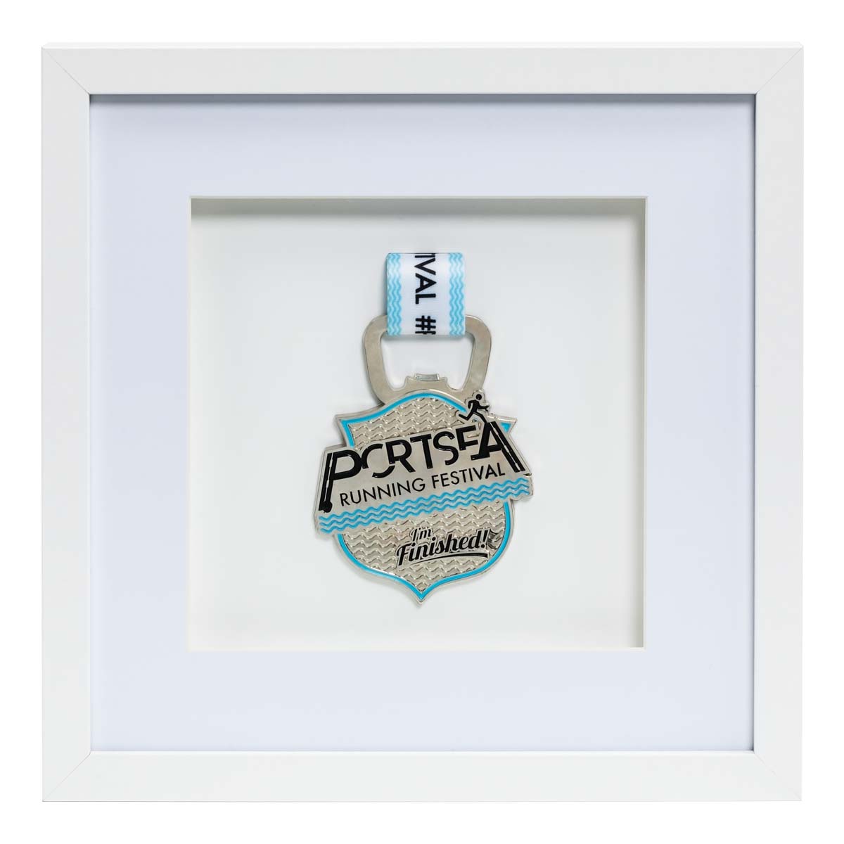 Silver medal from the Portsea Running festival framed in a white square frame, front on angle