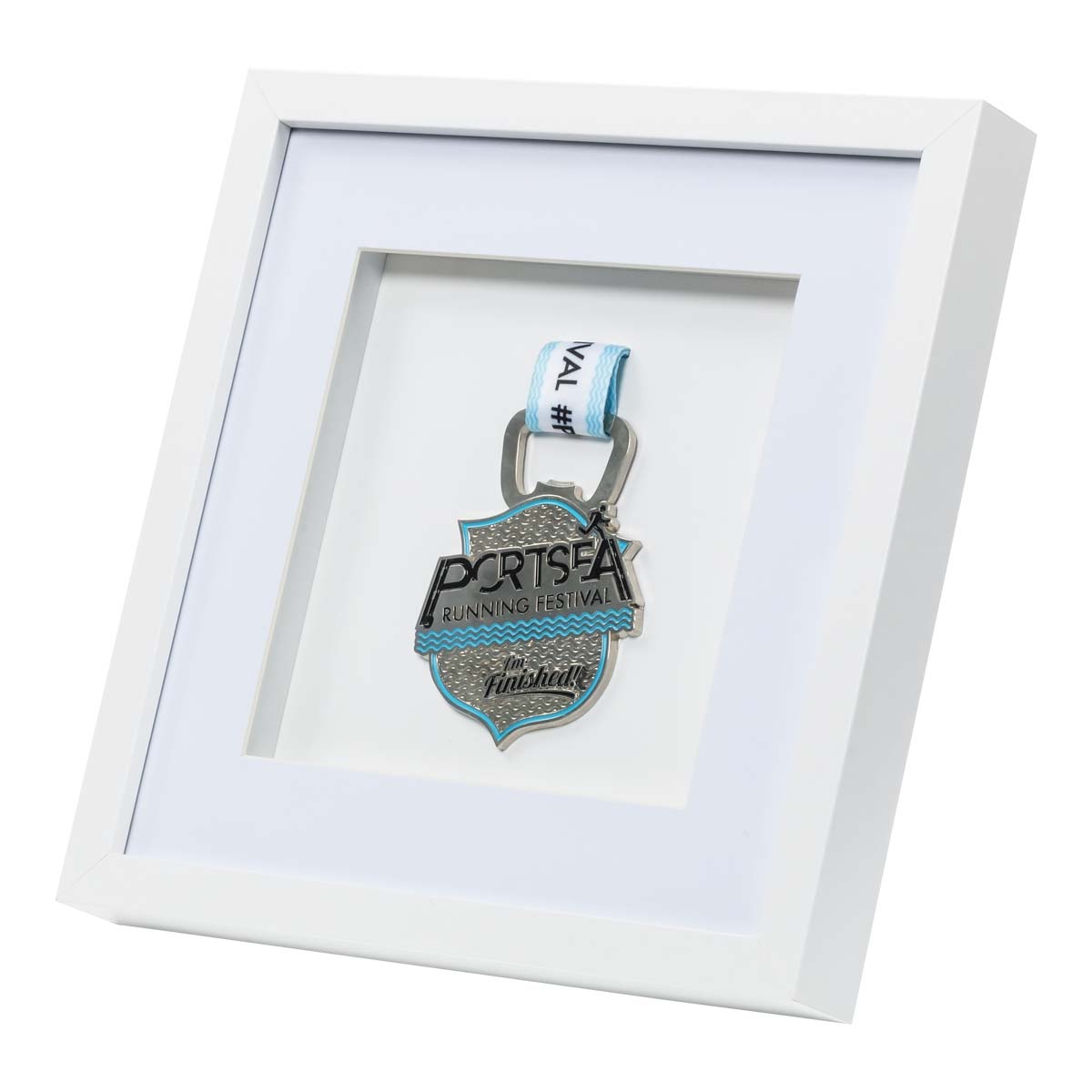 Silver medal from the Portsea Running festival framed in a white square frame, right angle