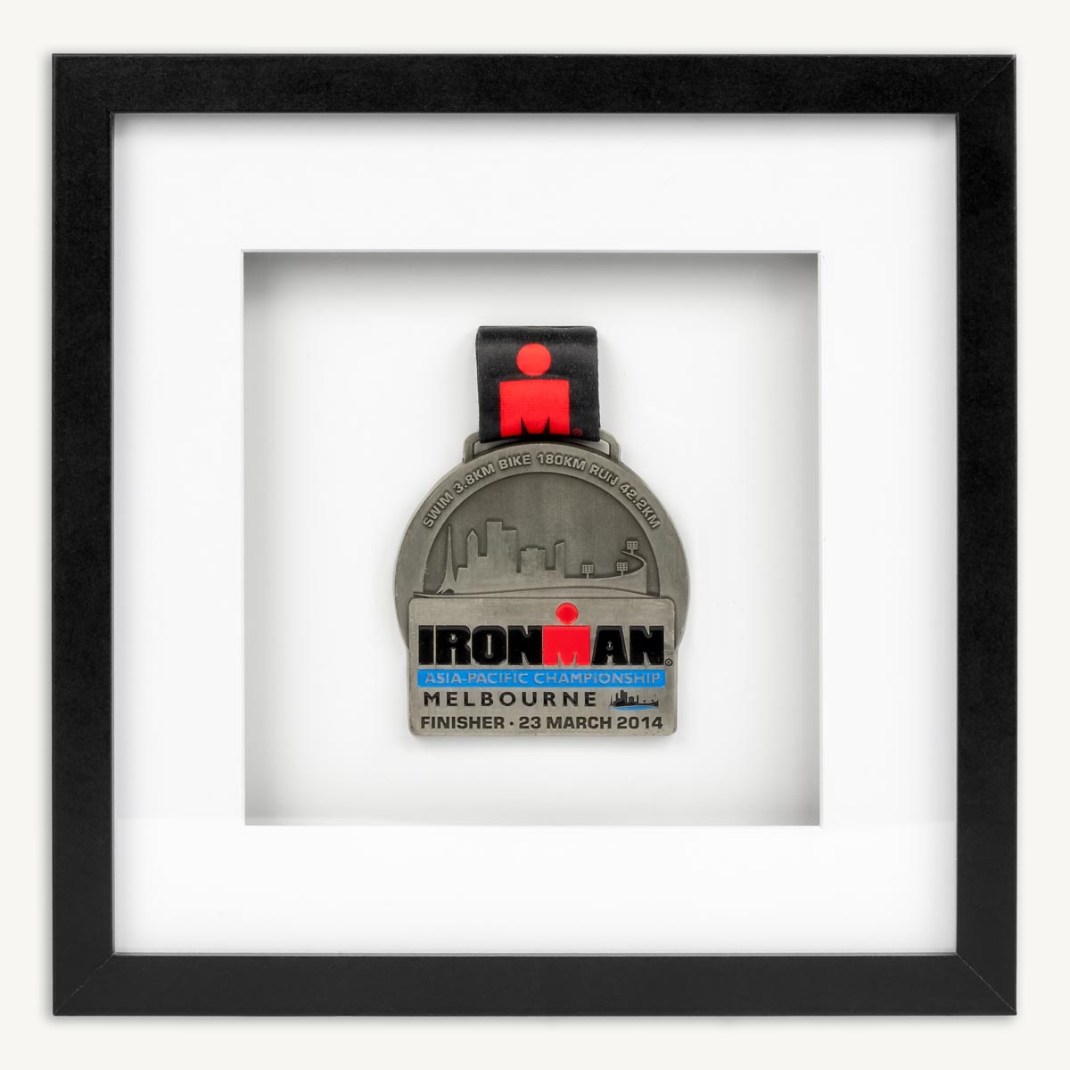 Ironman Melbourne medal in a square black frame