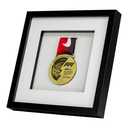 Gold medal from the Melbourne Marathon framed in a Black square frame, front angle