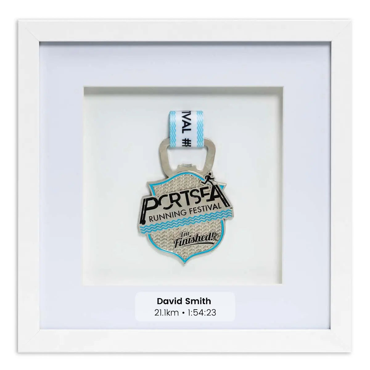 Silver medal from the Portsea Running festival framed in a white square frame, front on angle. With Personalisation Label.